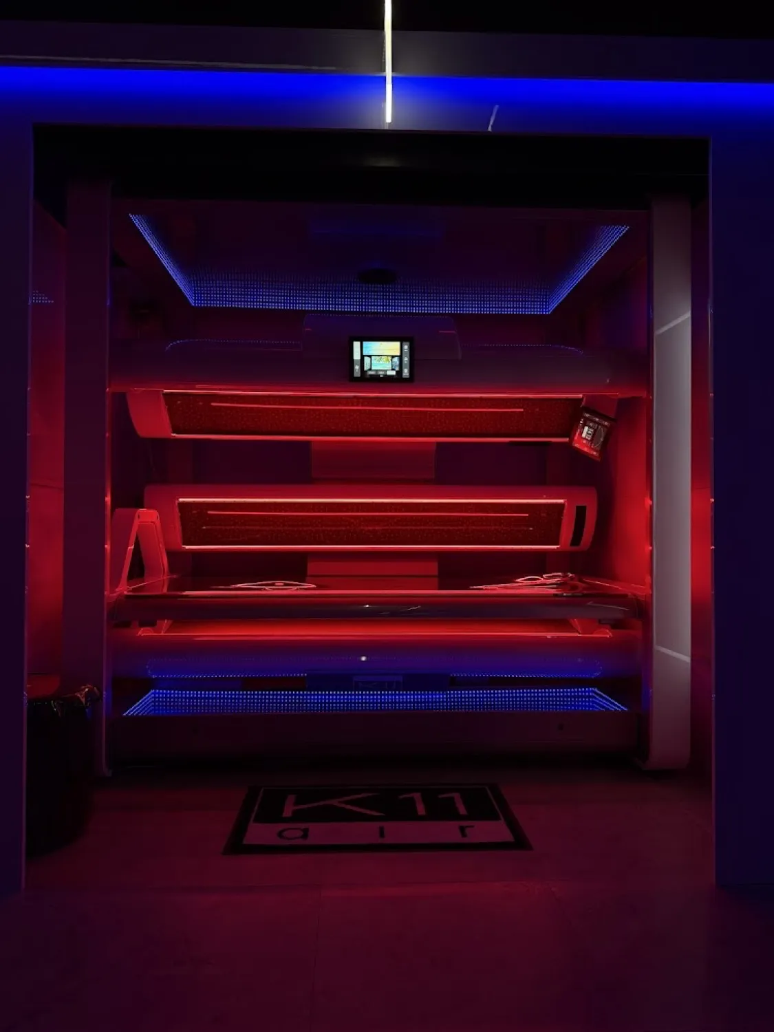 megaSun K11 lit in red at Deluxe Tanning Studio